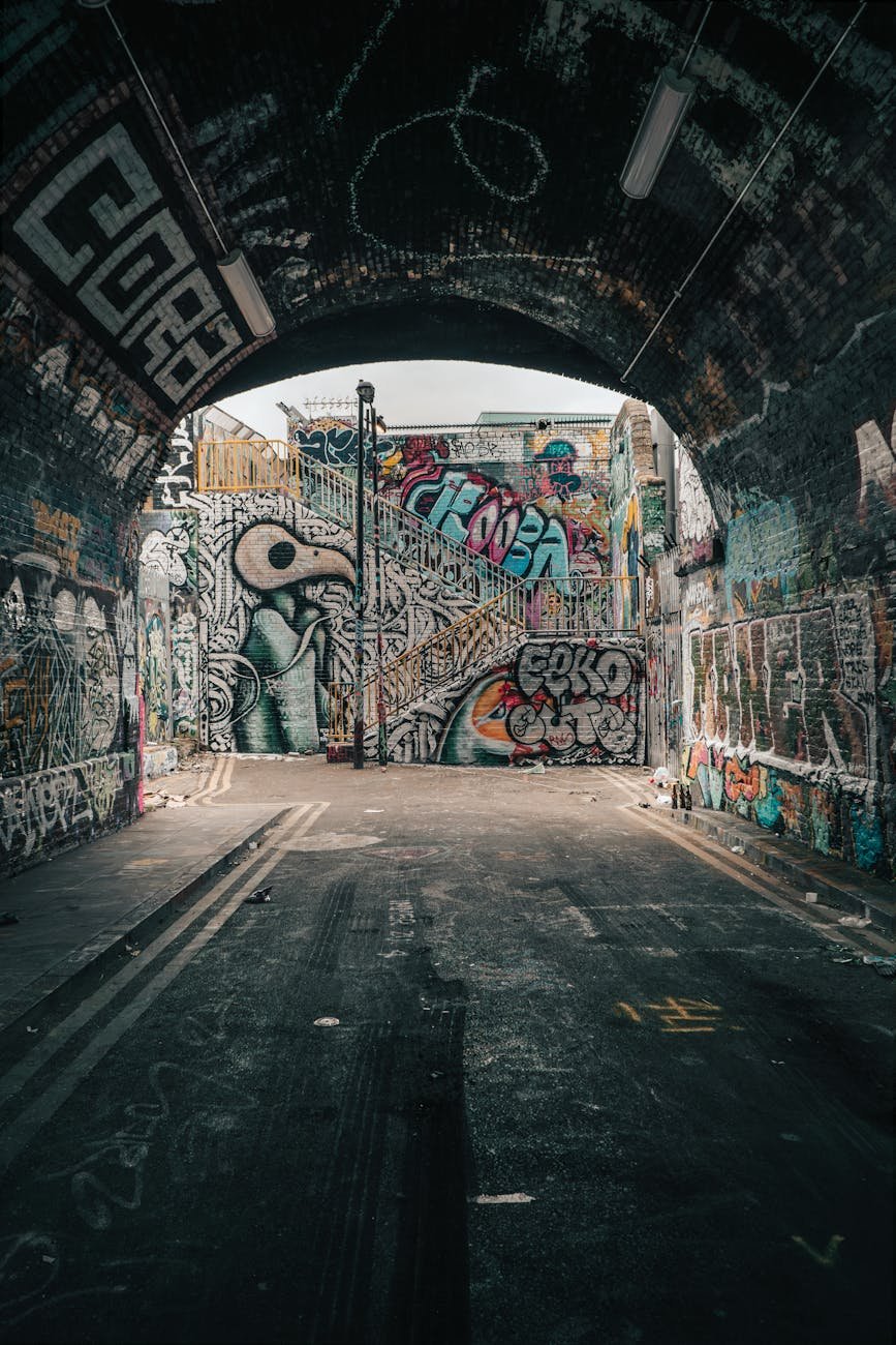 a tunnel with walls covered in graffiti